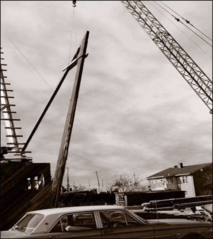 A 1964 historic construction photograph showing the massive wooden A-frame structural beams being raised, which helped the church become the tallest building in Richmond at the time.